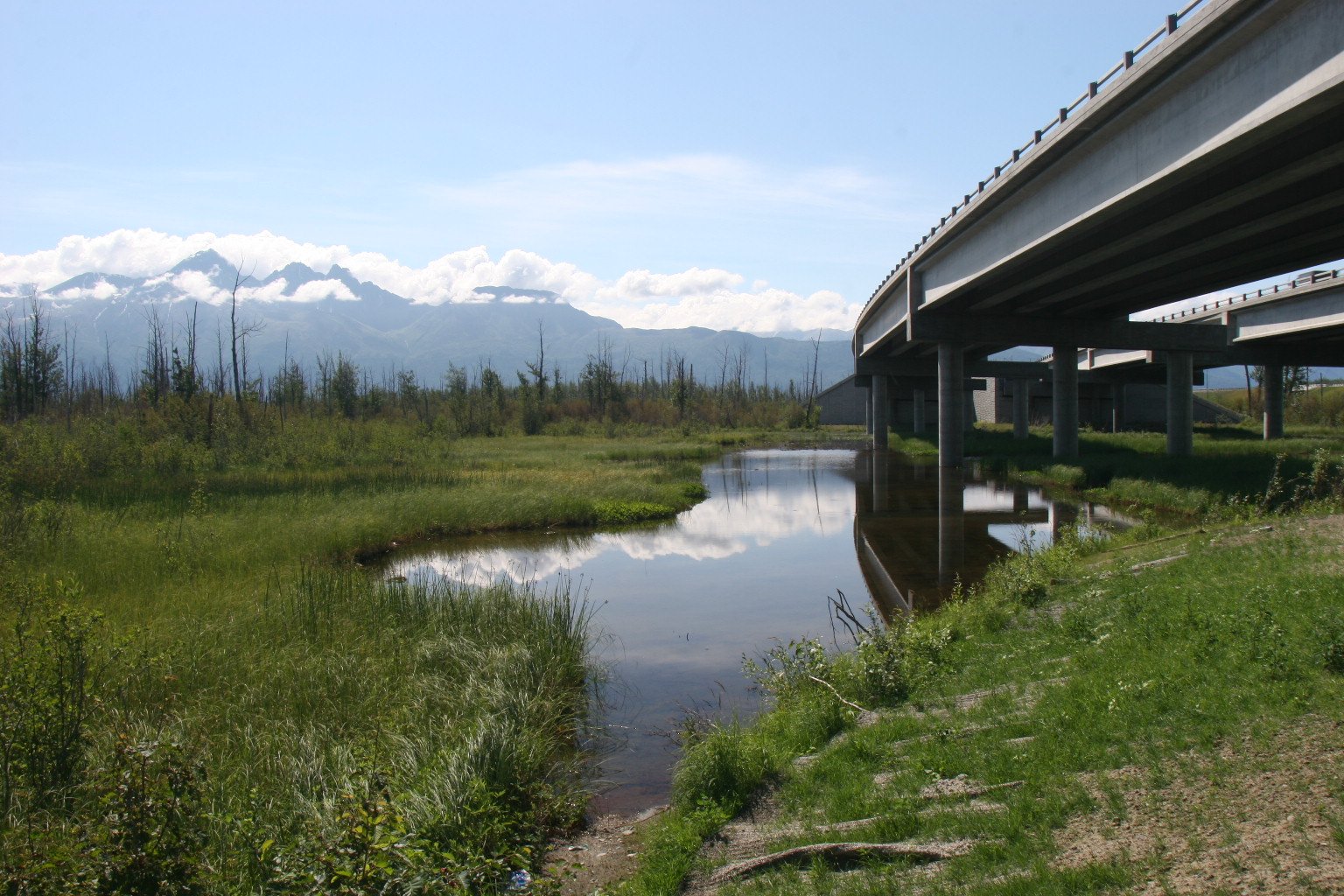 Bridge crossing a wide Alaska river valley