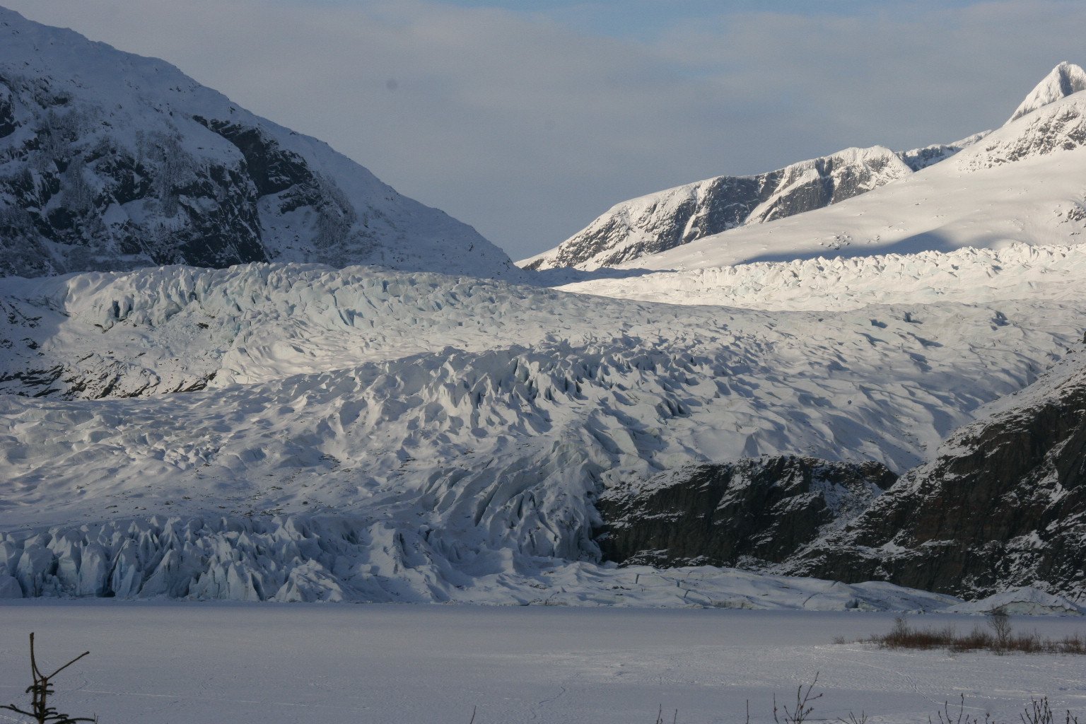 Glacier flowing between Alaska mountains