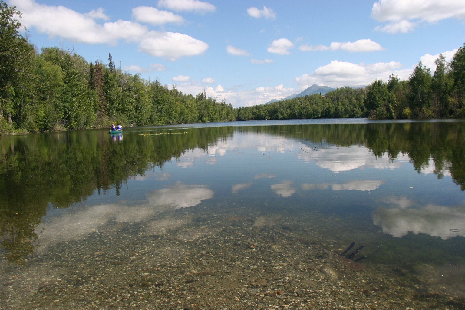Lake reflection with a small boat