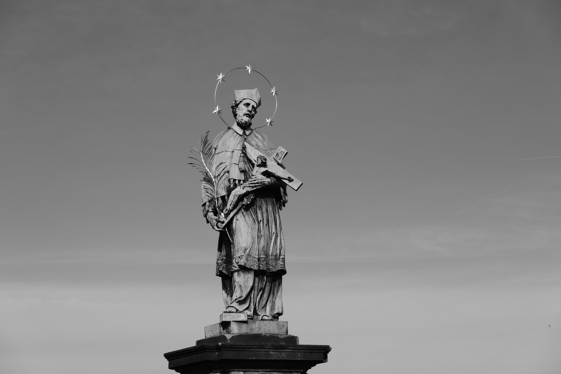 Black and white photo of a statue on a pedestal