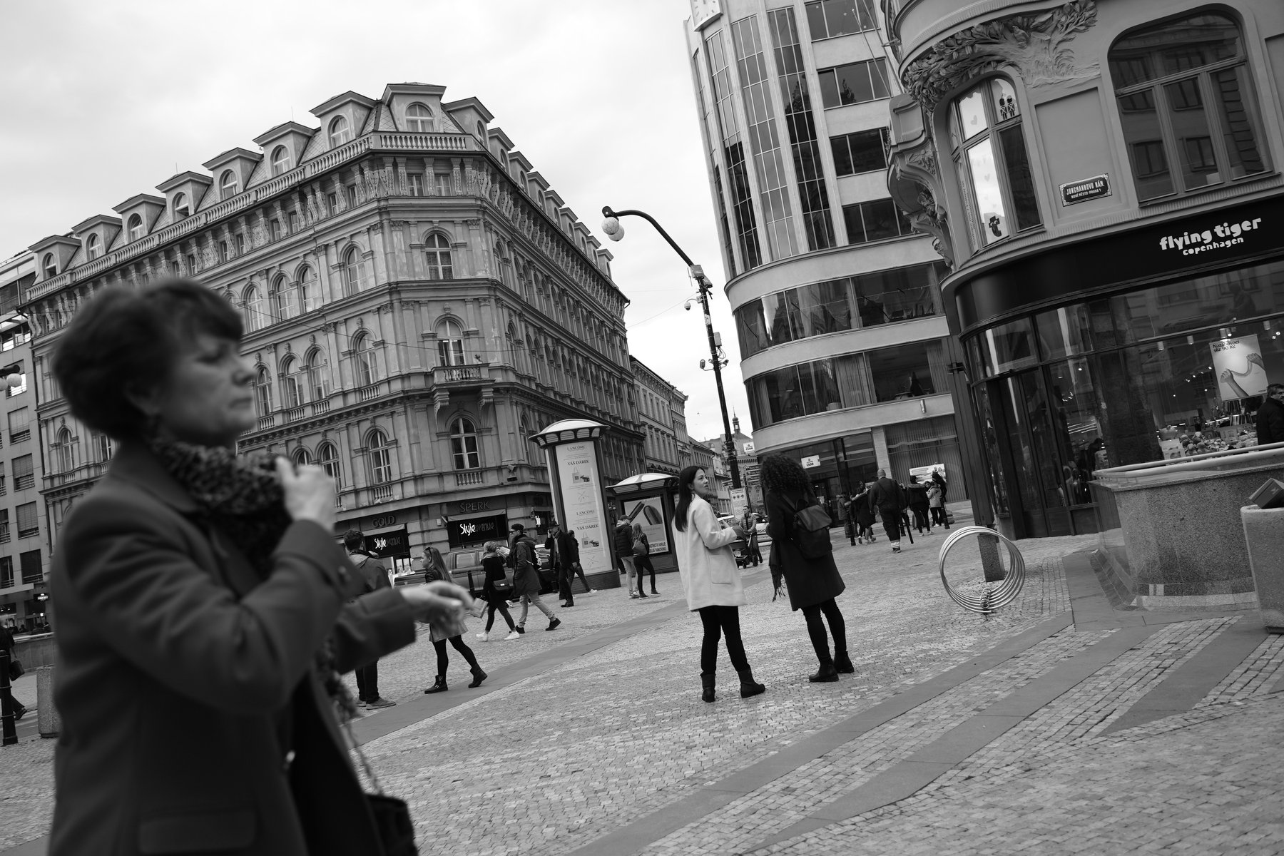 Black and white candid street photo of a woman